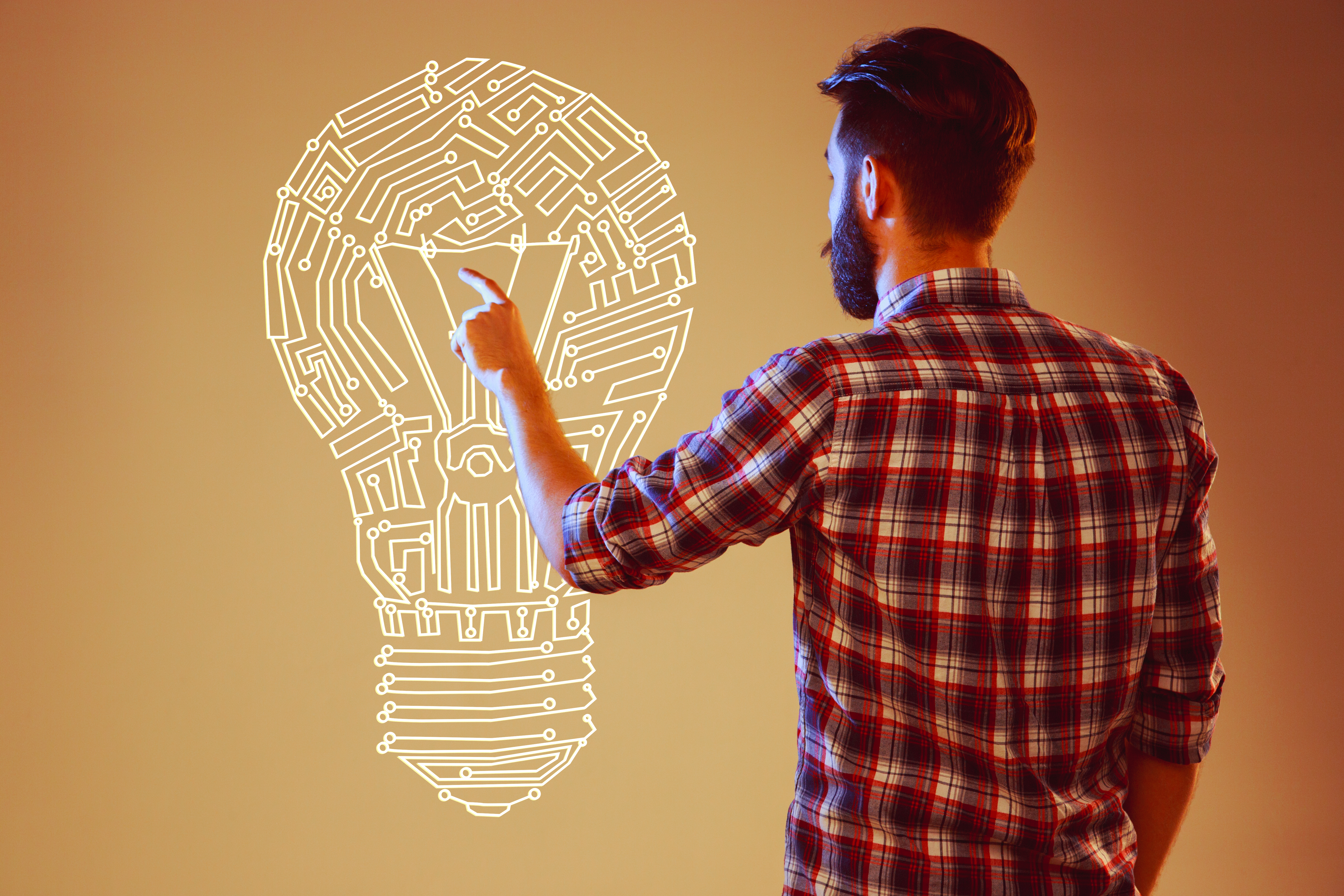 Handsome young man with idea bulb on abstract lamp background. Concept new idea